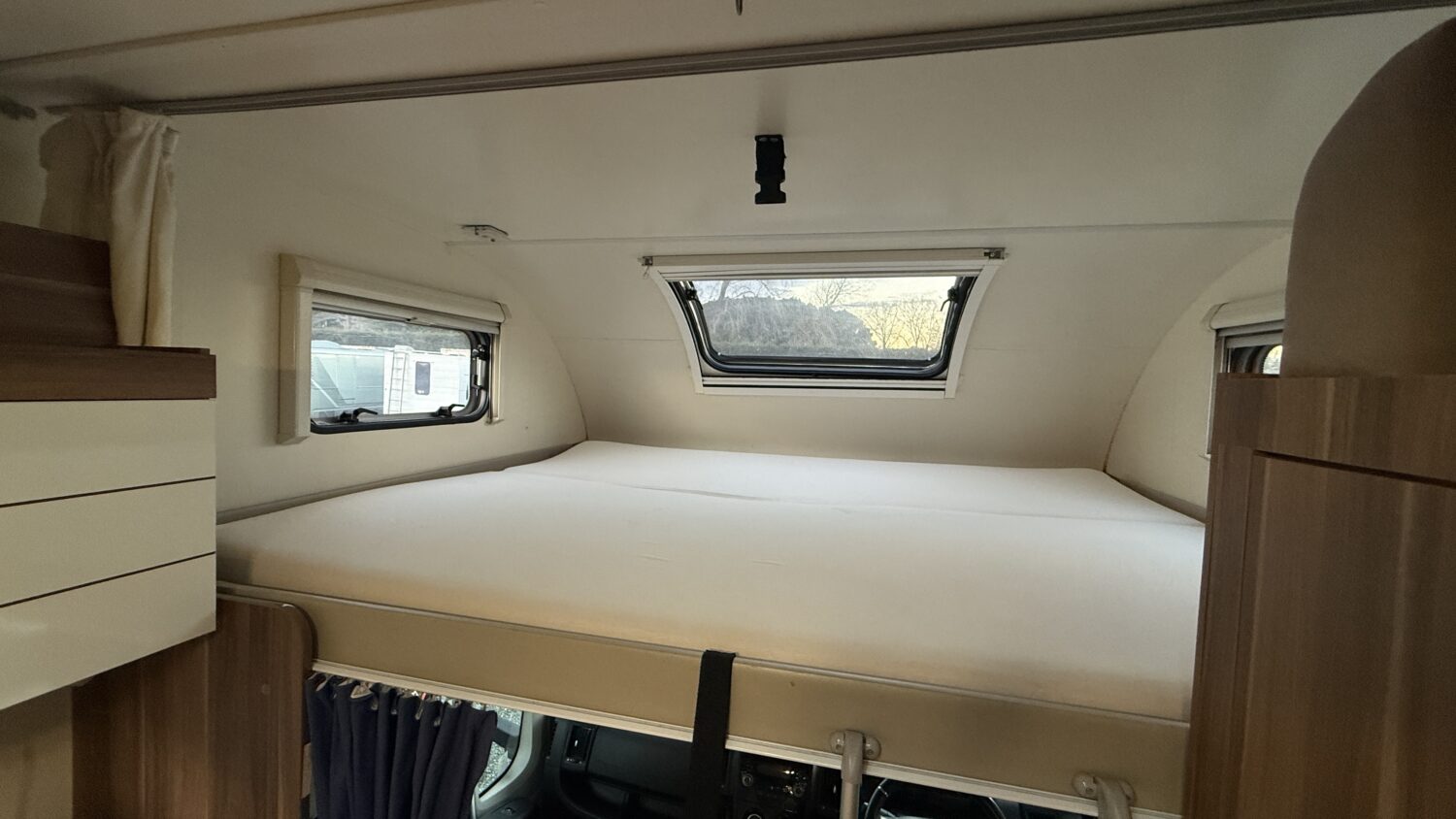 Rosy 6 berth campervan rental in New Zealand with bike rack, awning and spacious family motorhome layout.
